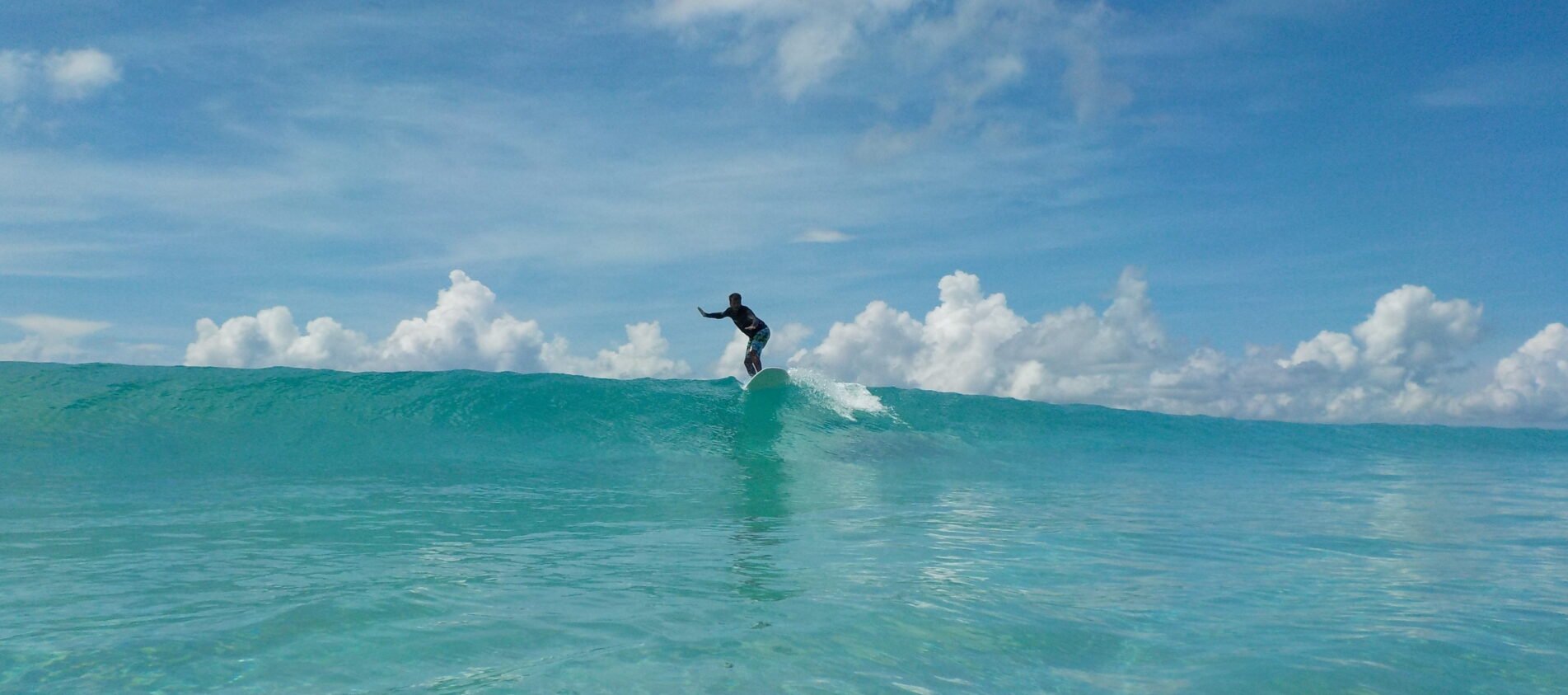 surfing at radhanagar beach, havelock, andamans